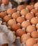 close up of brown eggs in carton
