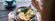 Over the shoulder view of woman eating breakfast
