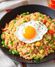 Fried rice in a black bowl with a fried egg on top