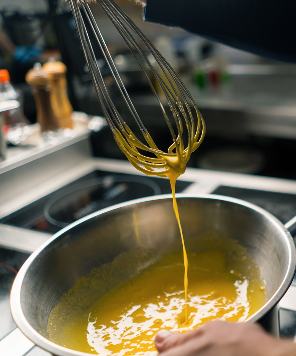 Whisking eggs in a metal bowl
