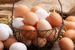 Wire basket filled with white and brown eggs