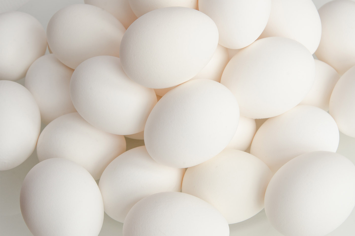 Close up of pile of white eggs