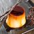 Classic flan displayed with two stems of vanilla