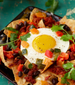 A plate of nachos libres with an egg on top.