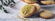 Pistachio cookies with eucalyptus leaves in a bowl.